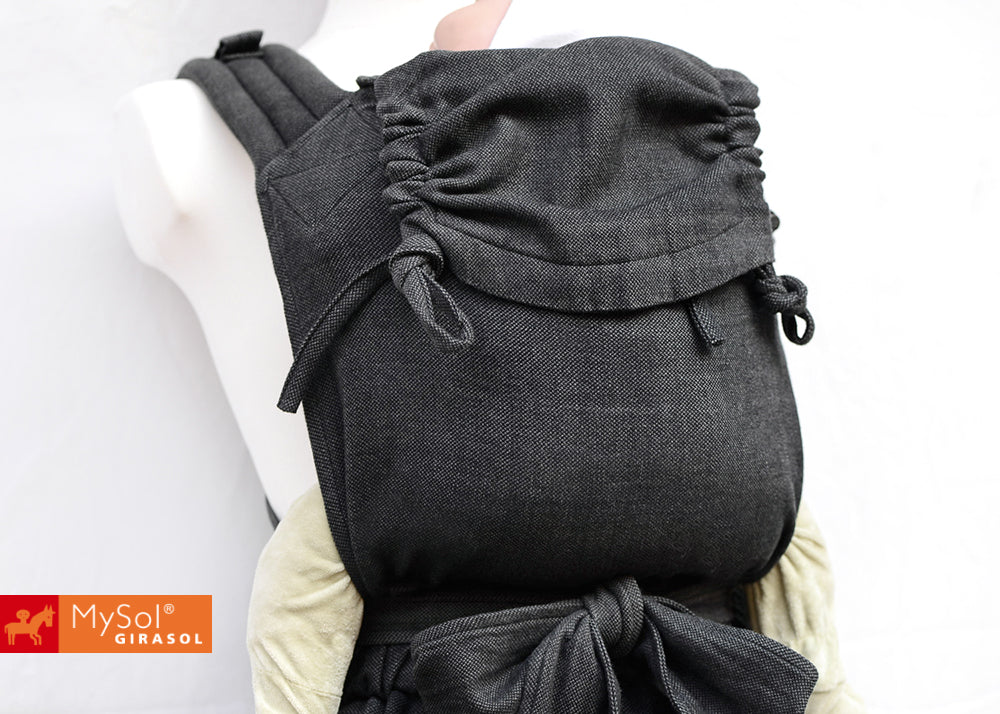 Black baby carrier worn by a mannequin on a white background with MySol Girasol logo.